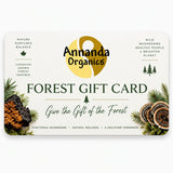 A Forest Gift Card from Annanda Organics featuring a cream background with green and gold branding, pine and mushroom illustrations, and the text 'Give the Gift of the Forest'.